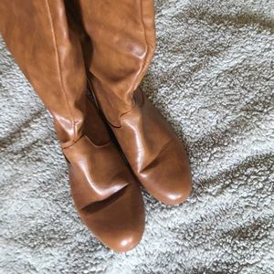 Thigh high tan boots.